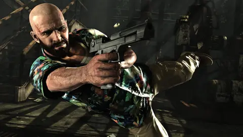 Max Payne com camisa havaiana e arma em punho em cena de Max Payne 3