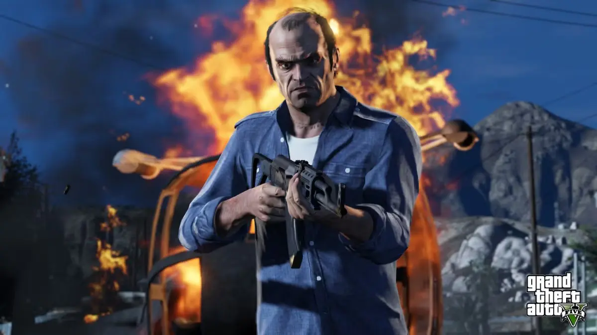 Trevor, personagem de GTA V, empunha um fuzil diante de uma explosão e de um veículo em chamas