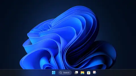 Área de trabalho do Windows 11 com papel de parede azul e barra de tarefas com botão Iniciar e busca.